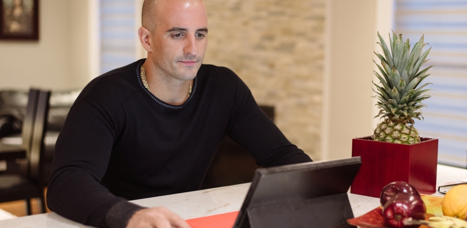 Customer working from home on his laptop.