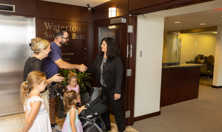 Personal Loan Officer greeting customers in the lobby of the WSB Main Office.