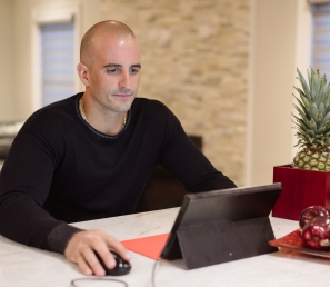 Customer working from home on his laptop.