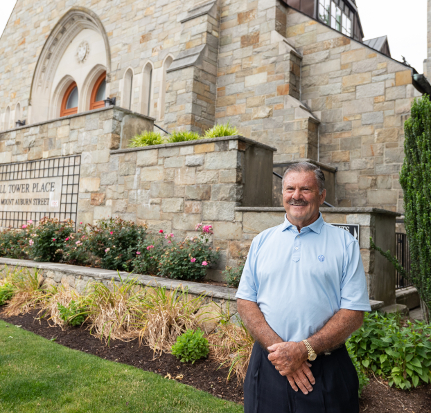 Customer standing in front of a condo building from a converted Church.