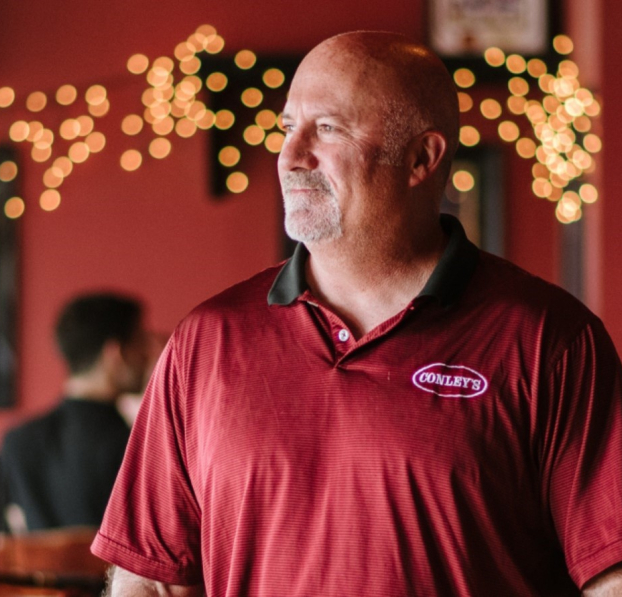 Restaurant owner looking out the window.
