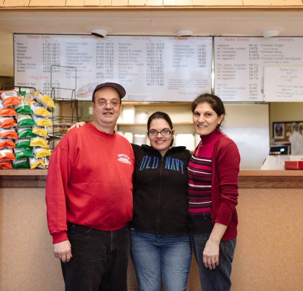 Parents with daughter at their deli restaurants. 