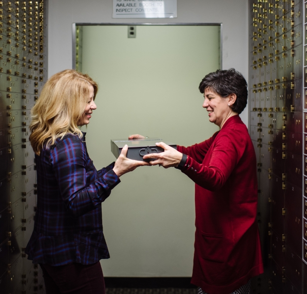 A WSB personal banker giving a customer her safe deposit box.