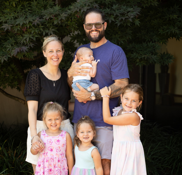 Young parents with their children standing in front of Watertown Savings Bank.