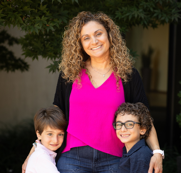 Young mom with her two sons standing in front of Watertown Savings Bank.