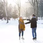 Couple holding hands while skating
